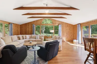Bright vaulted living room with wooded views and spacious seating