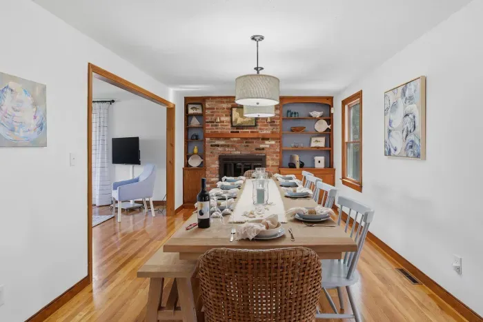 Bright dining room for 8–10 with fireplace, built-ins, and lounge flow