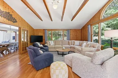 Bright, spacious living room with woodland views and plenty of seating