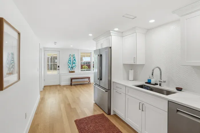 Bright modern kitchen with stainless appliances and airy coastal style