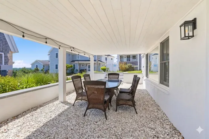 Spacious covered patio with outdoor dining and coastal charm