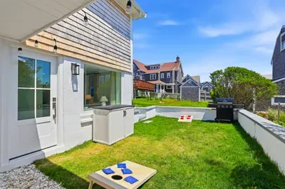 Private backyard with grill, lawn games, and sunny outdoor space