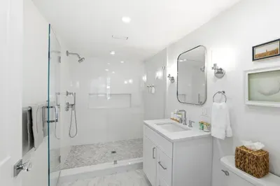 Bright spa-style bathroom with glass walk-in shower and modern finishes