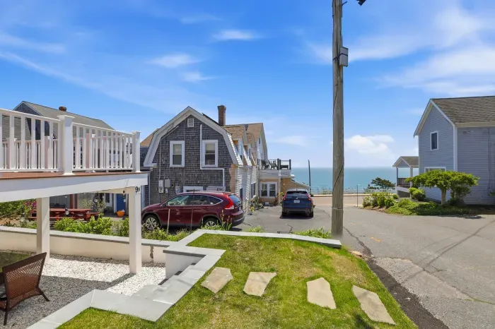 Beachside setting with ocean views, deck space, lawn, and easy parking