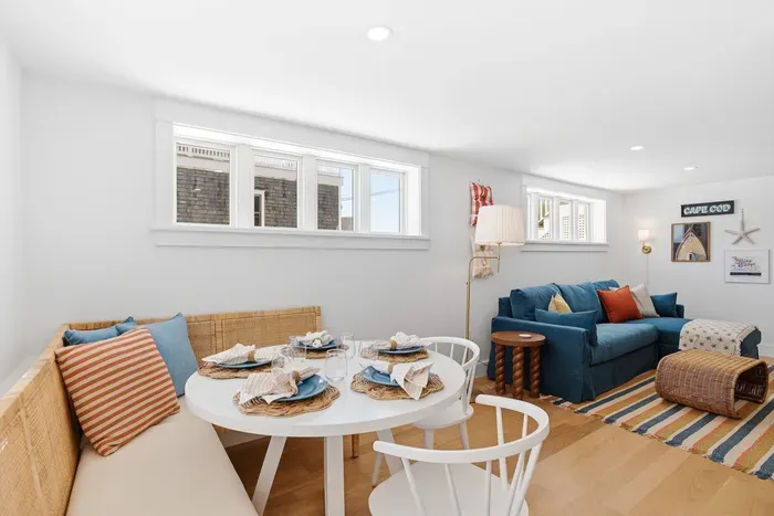 Bright coastal living area with banquette dining and cozy lounge seating
