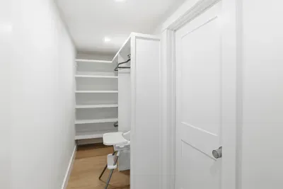 Bright walk-in closet with built-in shelves and family-friendly extras