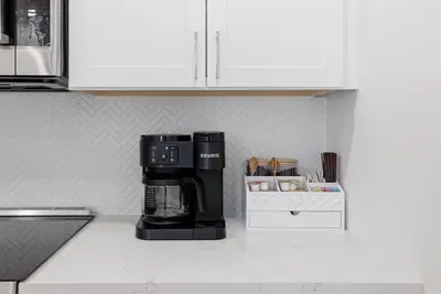 Modern kitchen coffee station with Keurig and guest-ready essentials
