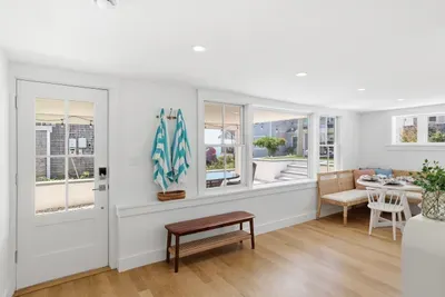 Bright coastal dining nook with natural light and easy outdoor access