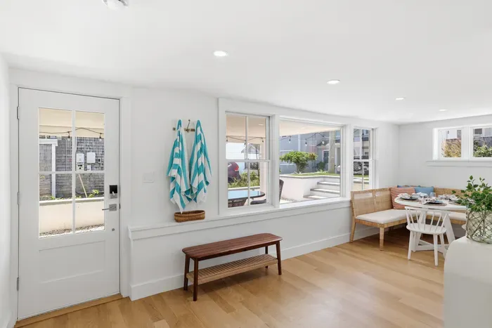 Bright coastal dining nook with natural light and easy outdoor access