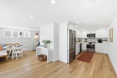 Bright open kitchen and dining area with modern finishes and cozy seating