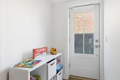 Bright entry nook with games, toy storage, and natural light