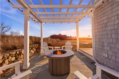 Evening Perfection by the Sea. Unwind completely. End your perfect beach day listening to the distant ocean waves while relaxing on the stone patio under the magical, softly-lit pergola.