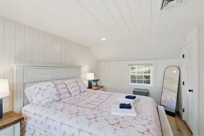 The bright, airy bedroom! Enjoy a comfortable  and fresh linens, also ample storage for unpacking.