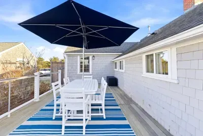 Enjoy meals on the deck under the large umbrella.