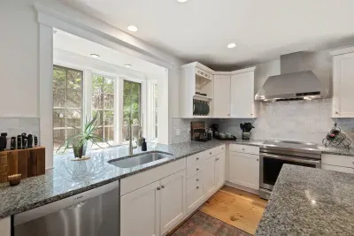 The window invites natural light to deep into the kitchen.