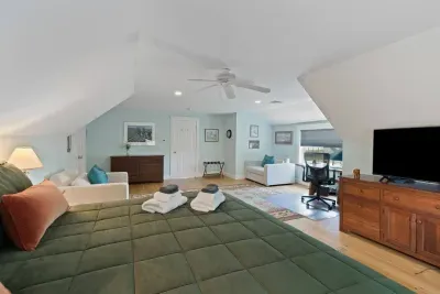 Upstairs king bedroom offering flexible sleeping arrangements with a comfortable king bed and two twin sleeper sofas – perfect for families or groups.