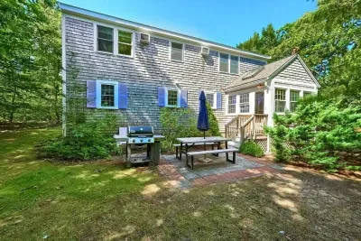 Perfect setup for summer cookouts! Enjoy the spacious patio area complete with a grill, picnic table, and umbrella