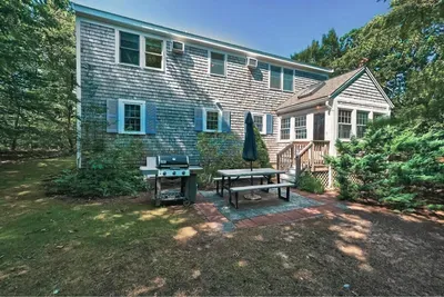 Perfect setup for summer cookouts! Enjoy the spacious patio area complete with a grill, picnic table, and umbrella