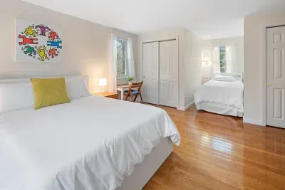 This spacious second-floor bedroom features a comfortable Queen bed and a Full-size bed