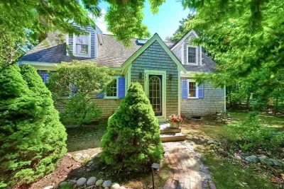 Welcome home! Features bright blue shutters and a lush, private setting