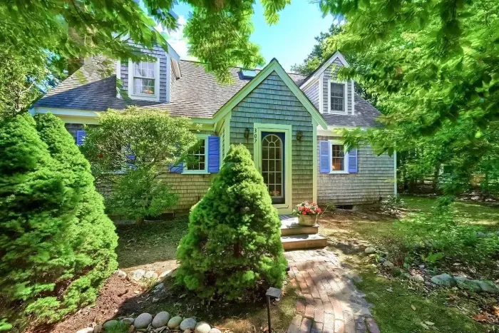Welcome home! Features bright blue shutters and a lush, private setting