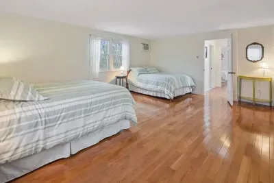 Generous bedroom space with beautiful polished floors and ample natural light.