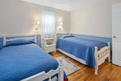 Twin beds and a nautical blue/white theme. Hardwood floors and plenty of closet space.