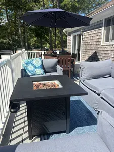 Private sunny deck with fire pit lounge and umbrella dining area