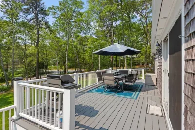 The deck offers a peaceful spot to relax with shaded seating and a BBQ grill
