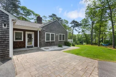This classic shingled home offers a perfect blend of rustic charm and updated amenities.
