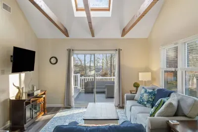 The sunroom is a bright and inviting space. It offers a lovely view of the deck, and a TV adds an extra touch of entertainment