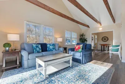 The living room is ready with a cozy sofa and a center table.