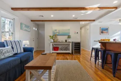 Relax in the living room with a comfy sofa, coffee and center tables.