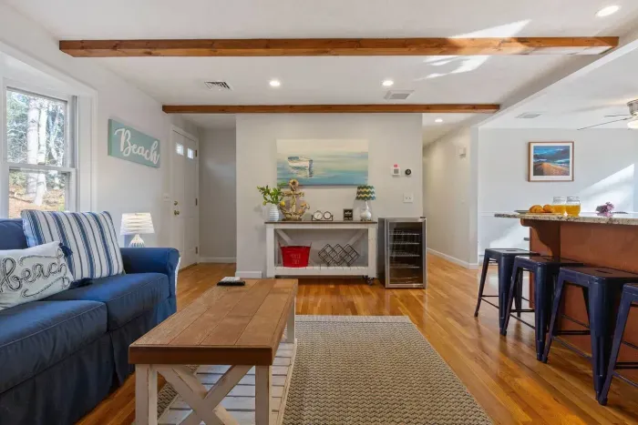 Relax in the living room with a comfy sofa, coffee and center tables.