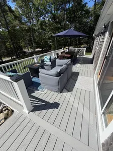 Private wooded deck with cozy lounge seating, fire pit, and outdoor dining