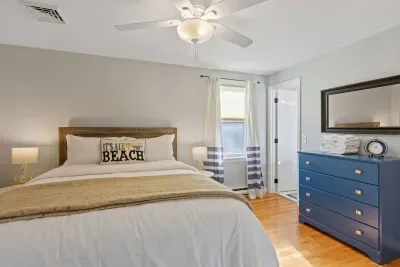 The main bedroom features a private attached bathroom and ample storage with a dresser.