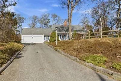 A paved driveway leads up to the house retreat.