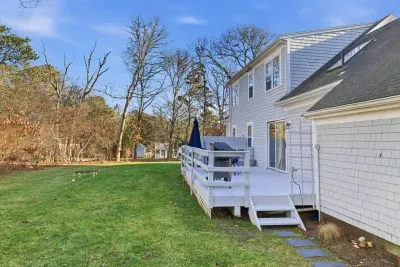 The back deck connects directly to the kitchen, making it effortless to step outside and enjoy the spacious backyard with a BBQ grill.