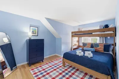 This bright blue retreat features a twin-over-queen bunk bed that makes sleepovers feel like an adventure