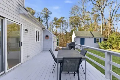 The deck is a natural extension of the kitchen, allowing you to easily grill and dine outdoors while soaking up the peaceful Harwich sentiment of this secluded, wooded property