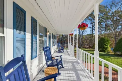 With blue rocking chairs and vibrant hanging flowers set the perfect stage for a slow morning.