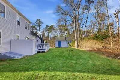 Open lawn behind the house that offers plenty of space for kids to enjoy the outdoors.