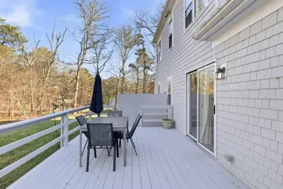 Creating the perfect setup for a backyard BBQ while the little ones play in the large, open yard