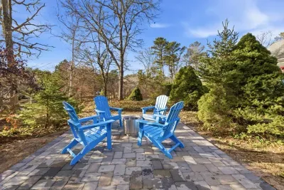 Situated on a lot surrounded by mature trees, offering a sense of privacy and nature.