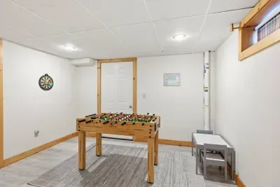 The ultimate rainy-day sanctuary! While the adults relax upstairs, the younger guests have their own world downstairs featuring a foosball table, a mini playhouse with a slide, and a cozy movie-watching corner.