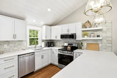 Bright modern kitchen with vaulted ceilings and stainless appliances