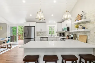 Bright modern kitchen with large island seating and deck access