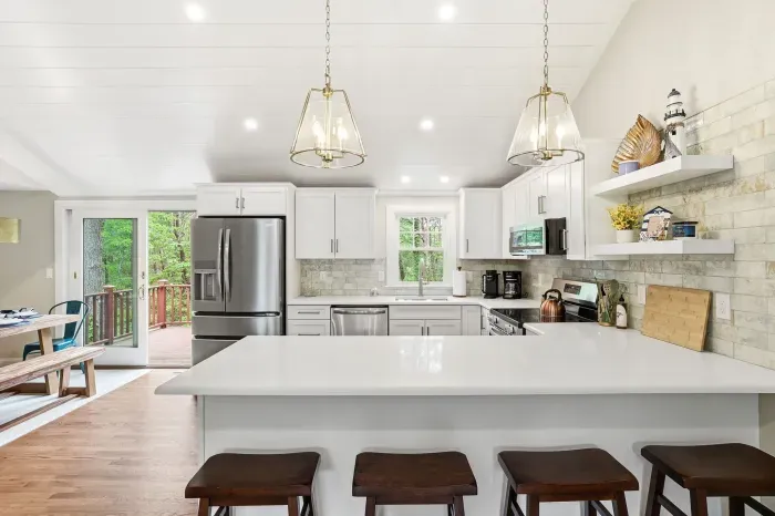 Bright modern kitchen with large island seating and deck access