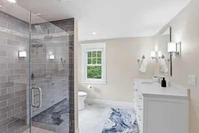 Bright spa-like bathroom with glass walk-in shower and roomy vanity