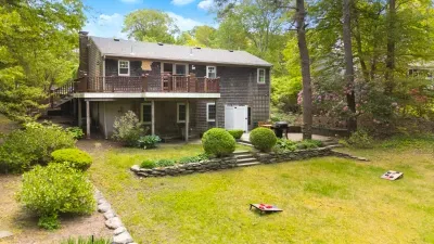Private wooded backyard with large deck, patio, and lawn games